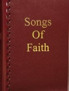 A red book with the words " songs of faith ".